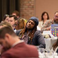 people at luncheon tables listening